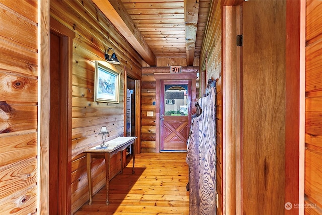 interior space featuring wood ceiling, log walls, and light wood-type flooring