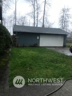 view of side of property featuring a yard and a garage