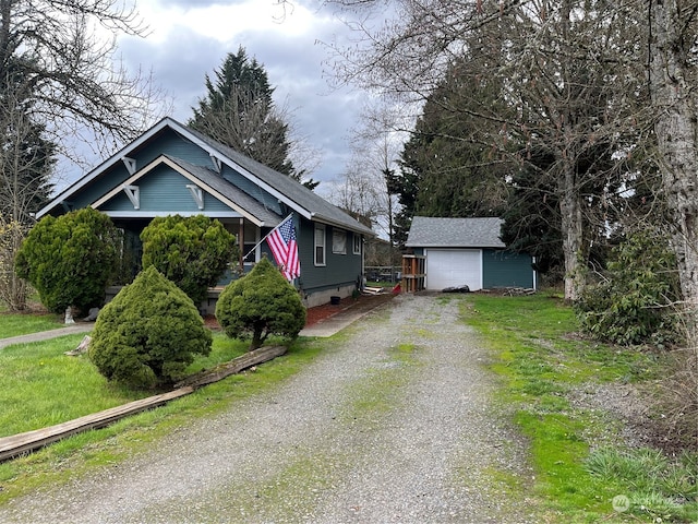 exterior space featuring a yard, an outdoor structure, and a garage