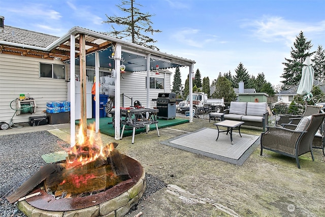 view of patio featuring area for grilling and an outdoor living space with a fire pit