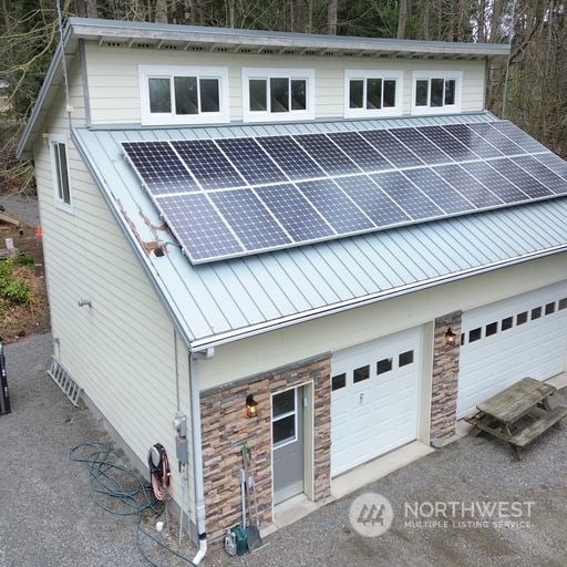 view of front of house with a garage and solar panels