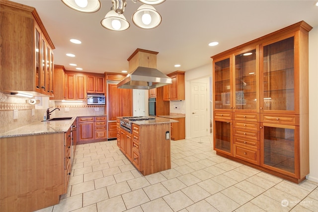 kitchen featuring sink, stone countertops, a kitchen island, light tile patterned floors, and stainless steel appliances