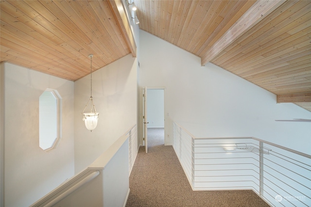 corridor featuring wood ceiling, carpet floors, beamed ceiling, and track lighting