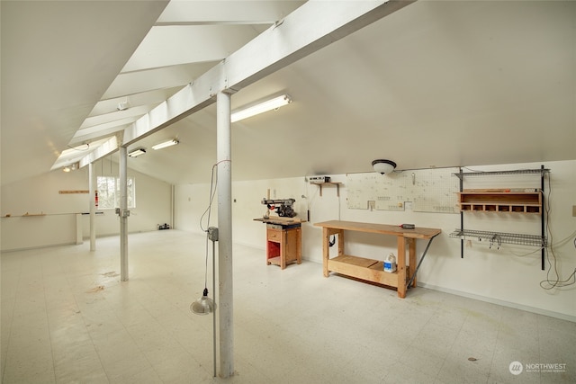 basement with tile patterned flooring and a workshop area