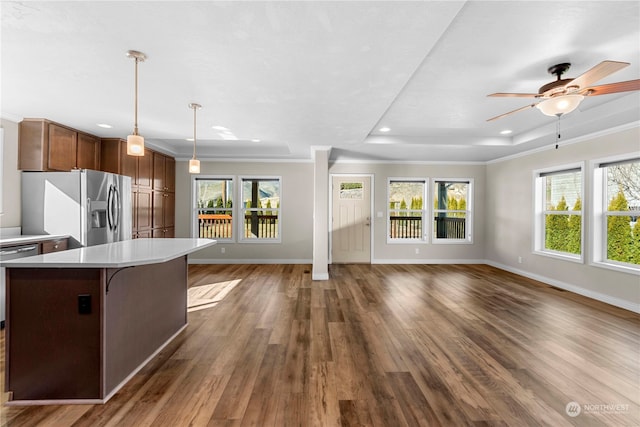 kitchen featuring appliances with stainless steel finishes, dark hardwood / wood-style flooring, and a healthy amount of sunlight