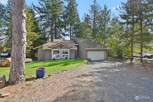 ranch-style home featuring a front yard and a garage