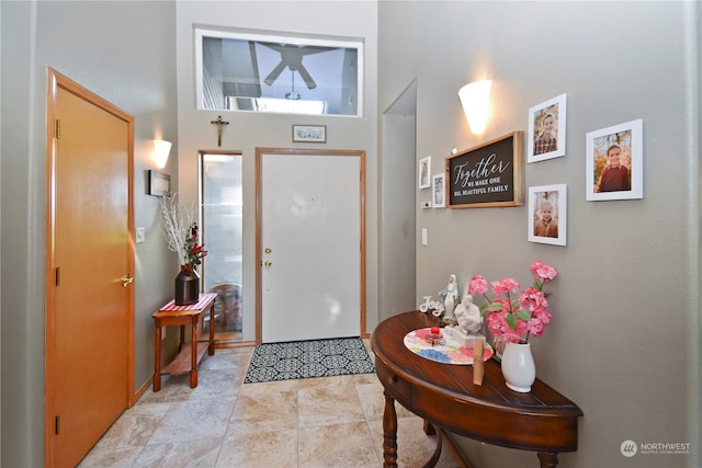 entryway featuring light tile floors and a high ceiling