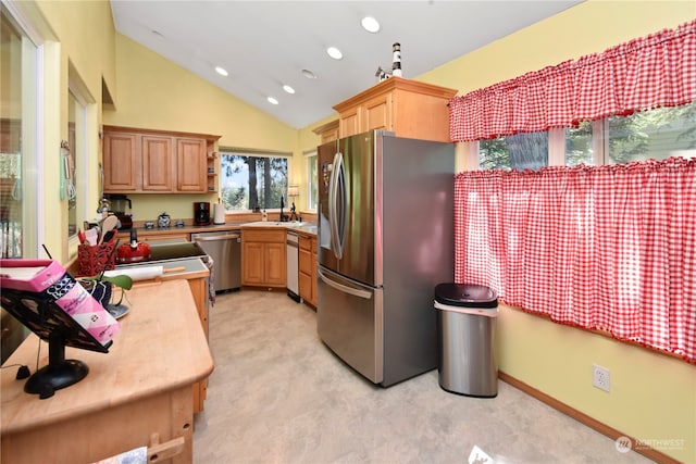 kitchen with high vaulted ceiling, appliances with stainless steel finishes, and sink