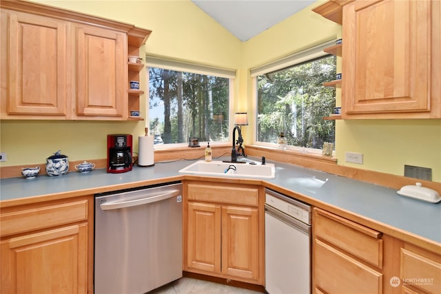 kitchen with dishwasher, plenty of natural light, vaulted ceiling, and white dishwasher