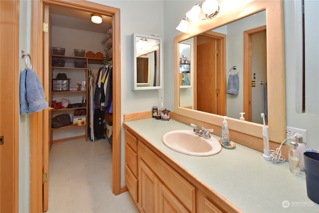 bathroom featuring concrete flooring and vanity