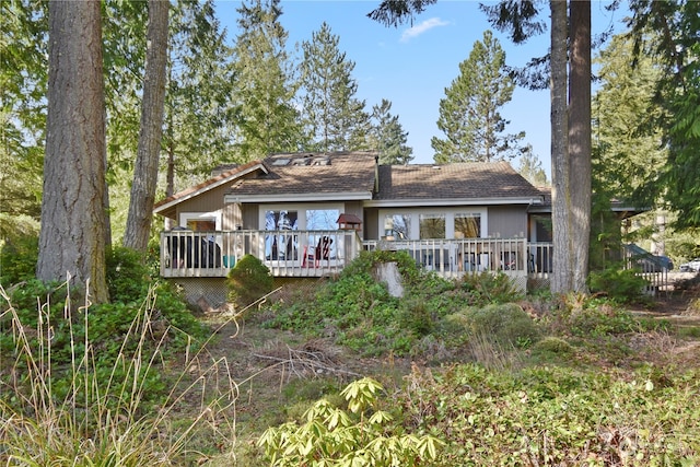 back of house featuring a deck