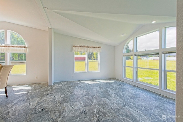 tiled spare room with vaulted ceiling