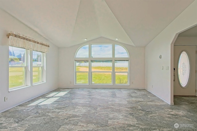 unfurnished living room featuring tile flooring and lofted ceiling