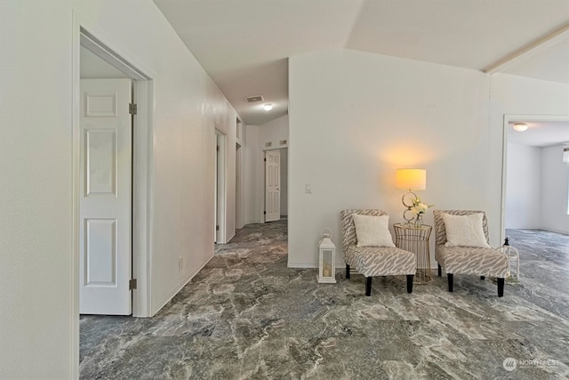 interior space with vaulted ceiling and dark tile floors