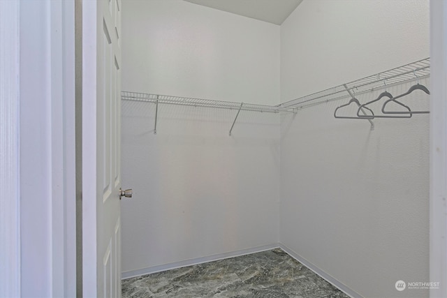 spacious closet with tile flooring