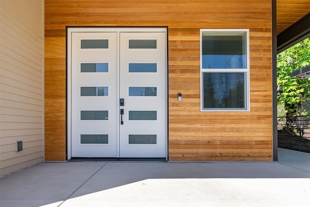 view of exterior entry with a patio