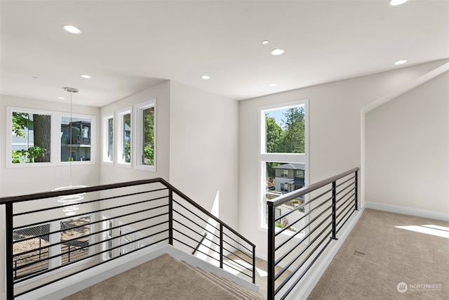 stairway featuring carpet flooring