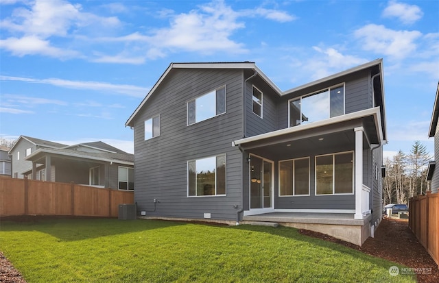 rear view of house with a yard, a patio, and central air condition unit