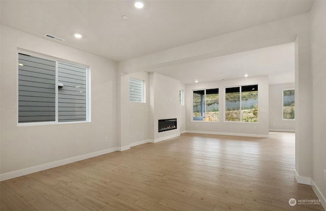 unfurnished living room with light hardwood / wood-style floors