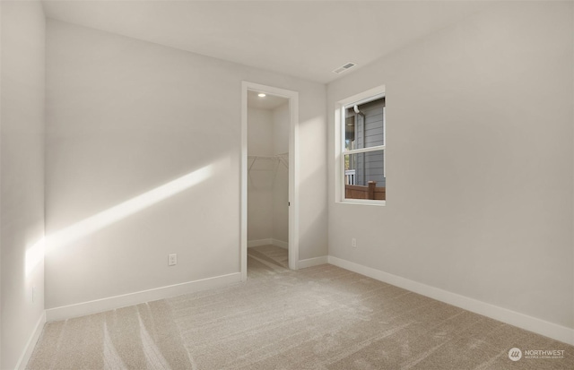 unfurnished room featuring light carpet