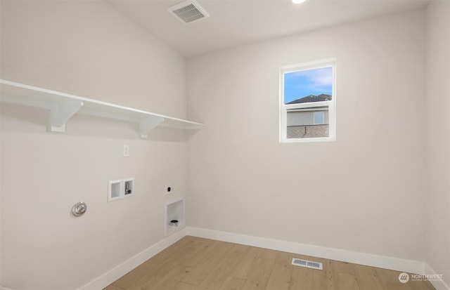 laundry room featuring hookup for a gas dryer, hookup for an electric dryer, washer hookup, and light wood-type flooring