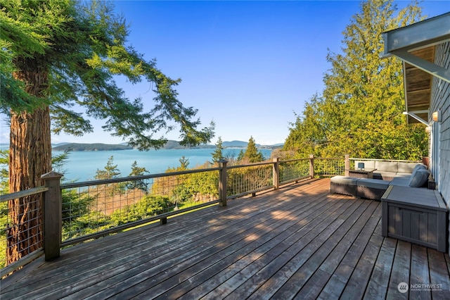 wooden deck featuring a water view