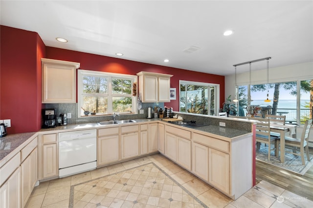 kitchen with sink, white dishwasher, light tile flooring, and pendant lighting