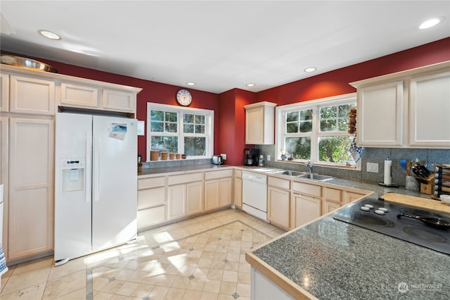 kitchen with backsplash, white appliances, sink, and light tile floors