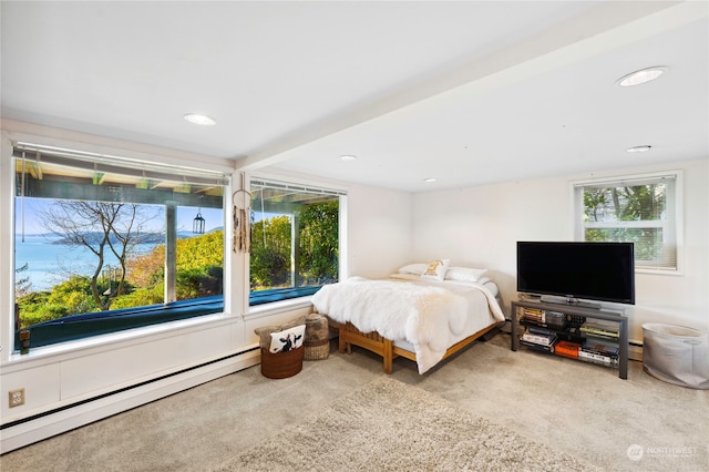 bedroom with light colored carpet and baseboard heating