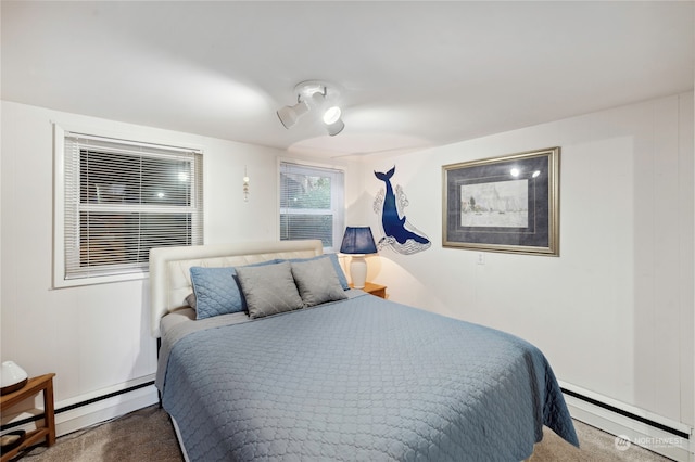 carpeted bedroom featuring baseboard heating