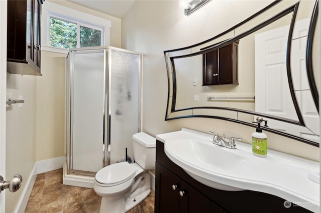 bathroom featuring oversized vanity, tile floors, a shower with shower door, and toilet