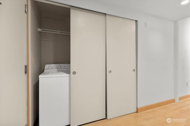 laundry room featuring light hardwood / wood-style floors and washer / dryer