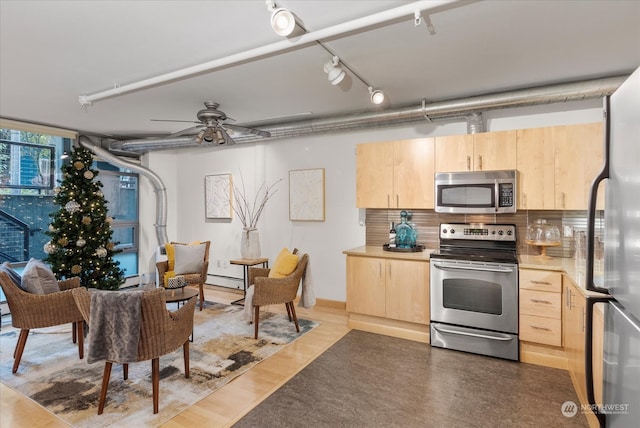 kitchen with ceiling fan, light brown cabinets, hardwood / wood-style floors, and appliances with stainless steel finishes