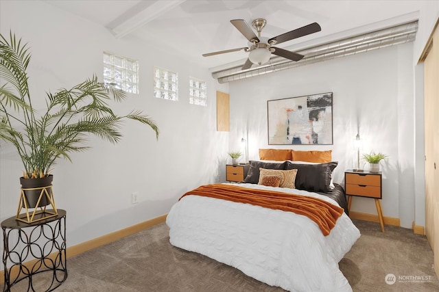 carpeted bedroom featuring ceiling fan, a closet, and beamed ceiling