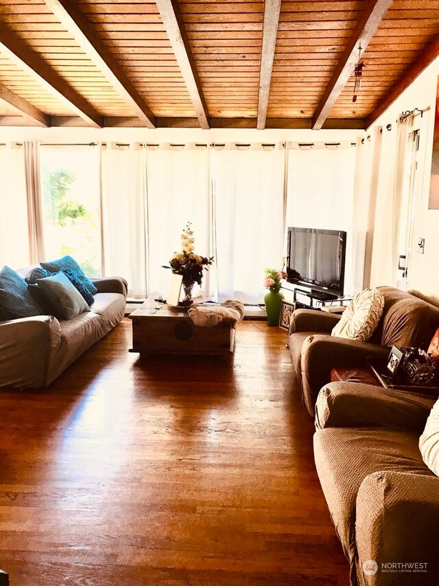 living room with baseboard heating, dark wood-type flooring, wooden ceiling, and beamed ceiling