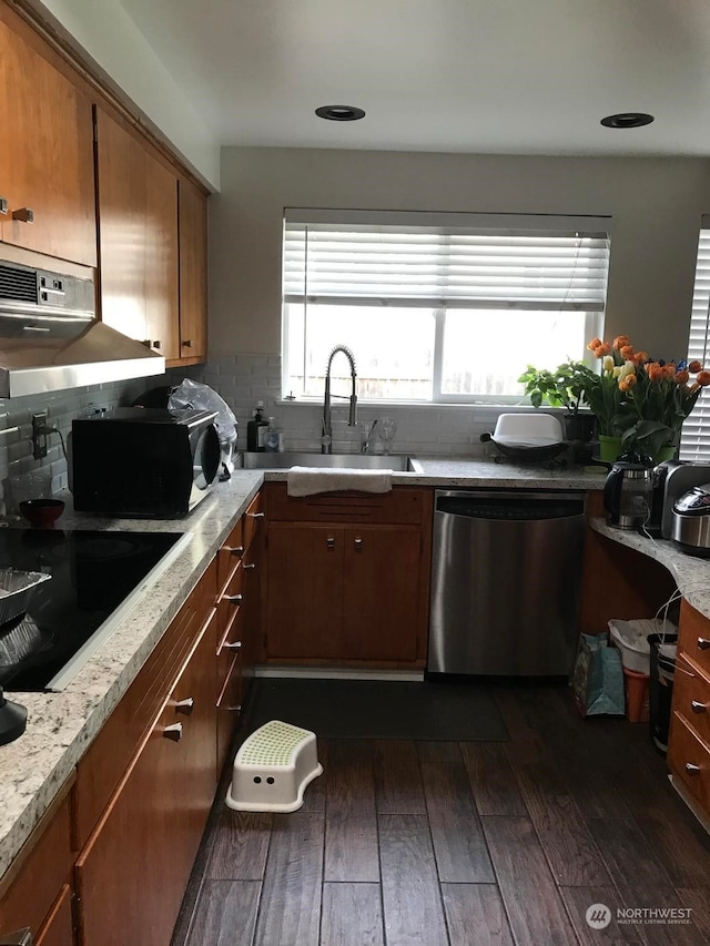 kitchen with tasteful backsplash, dishwasher, sink, and dark hardwood / wood-style floors