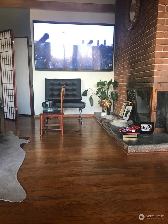 living room with dark hardwood / wood-style floors and a fireplace