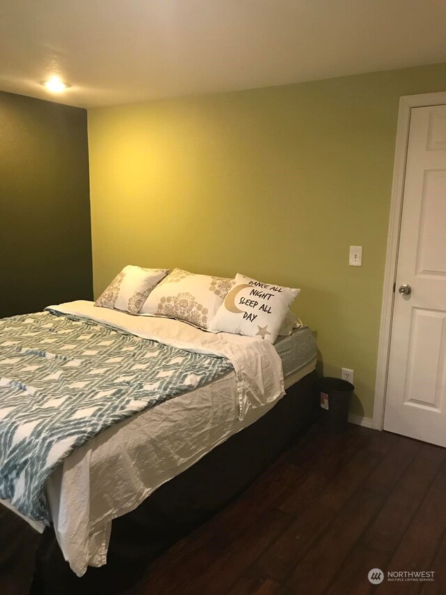 bedroom featuring dark wood-type flooring