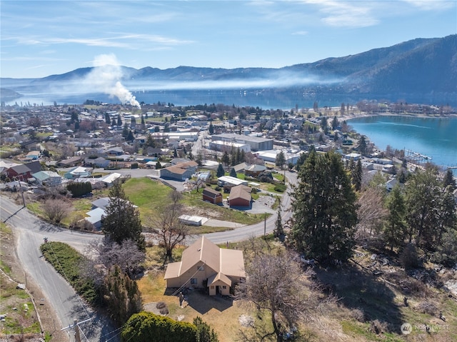 birds eye view of property featuring a water and mountain view