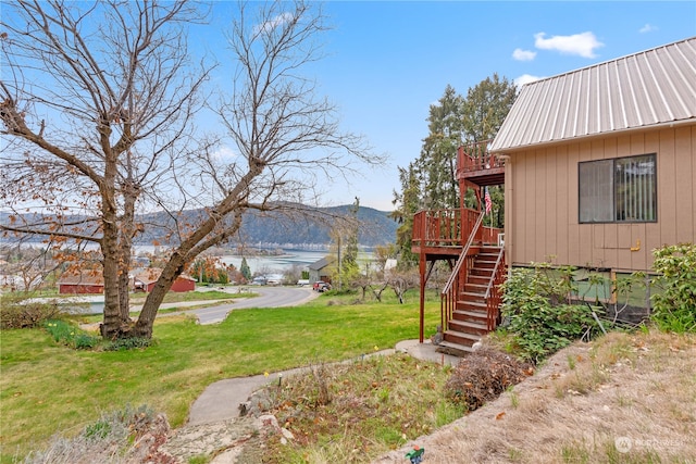 view of yard featuring a deck with mountain view