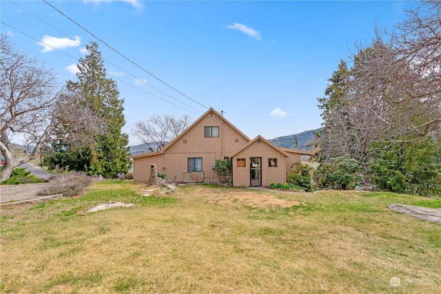 rear view of house with a yard