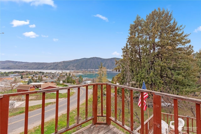 balcony featuring a water and mountain view