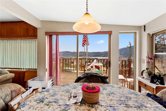 dining space with vaulted ceiling and a mountain view