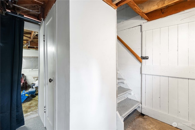 interior space with wood walls and concrete floors