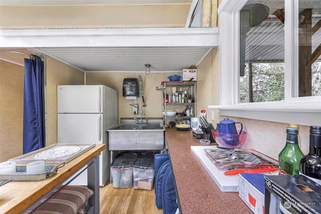 interior space featuring white fridge and sink