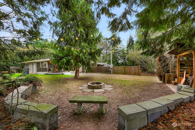 view of yard with an outdoor fire pit