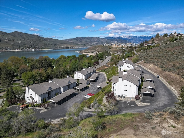 birds eye view of property featuring a water and mountain view