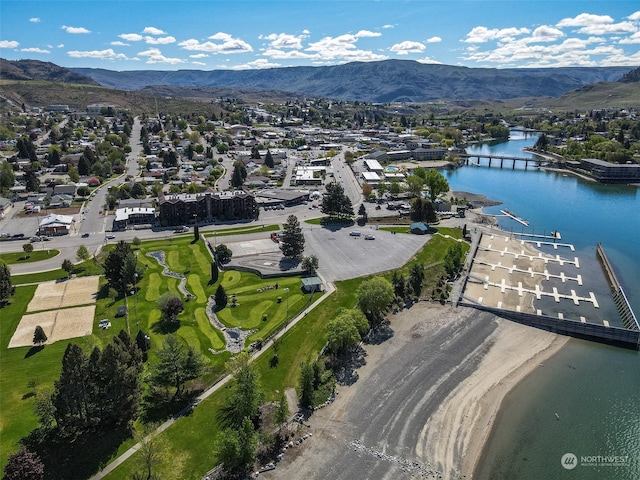 birds eye view of property with a water and mountain view