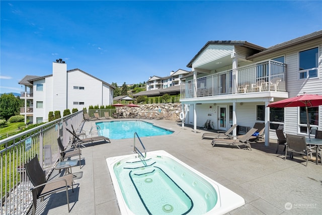 view of pool with a community hot tub and a patio