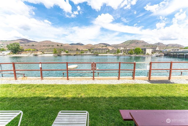 view of yard featuring a water and mountain view